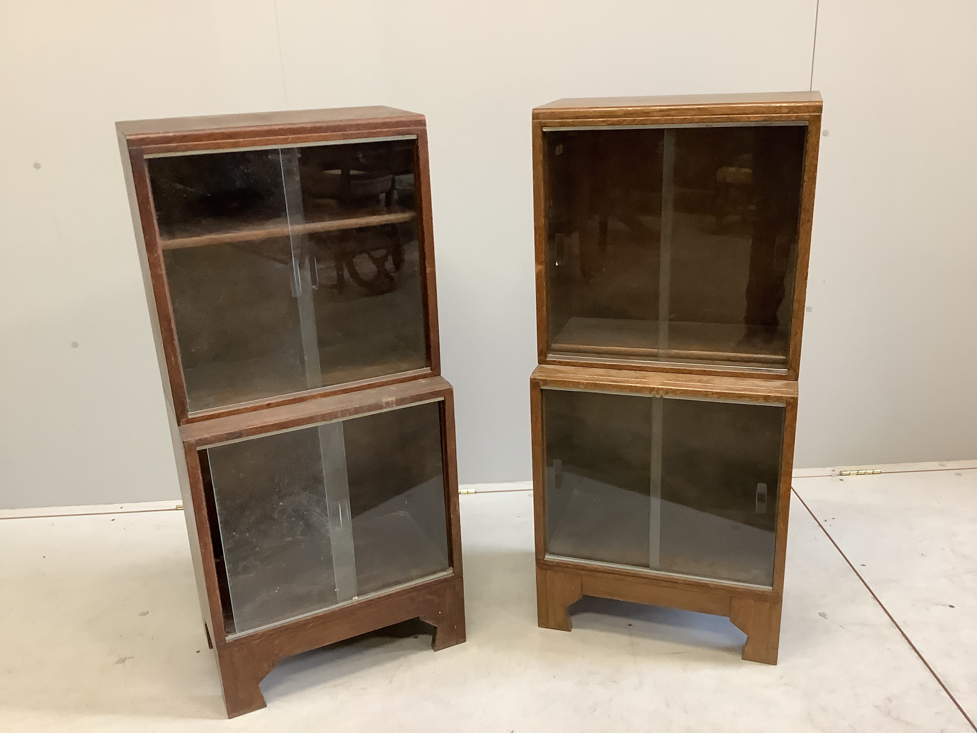 A pair of small Minty oak glazed two section bookcases, width 46cm, depth 29cm, height 102cm